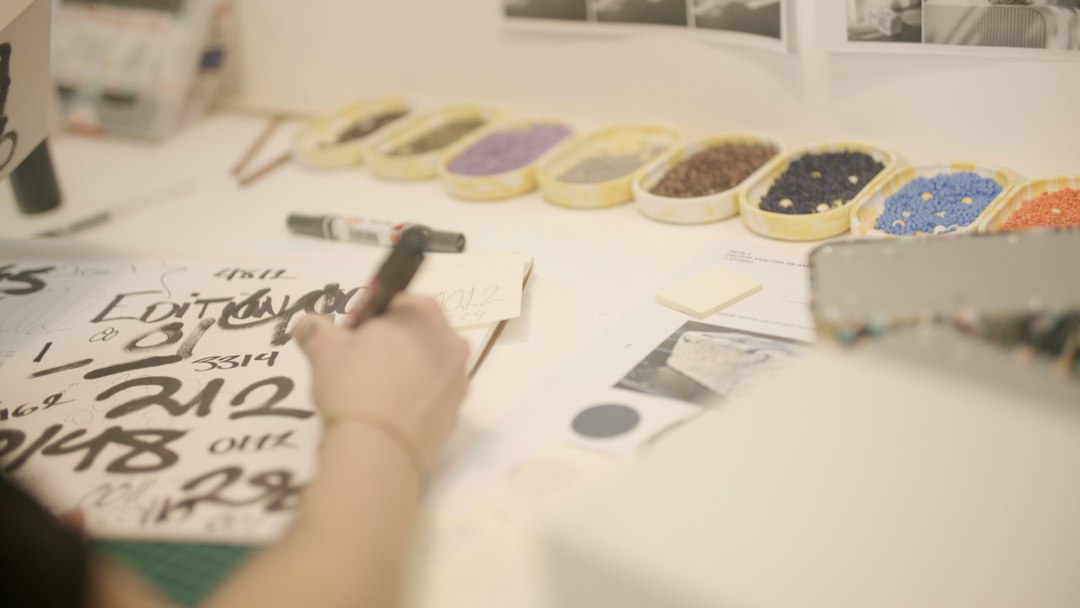 Creative brand moodboards, typography sketches, and physical mockups on an editorial desk