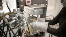 a woman working on a machine in a factory