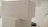 Stacked white boxes with minimalistic design featuring a label 'COLLECTION 1'. The setting appears to be clean and well-organized, possibly in a storage or retail environment.