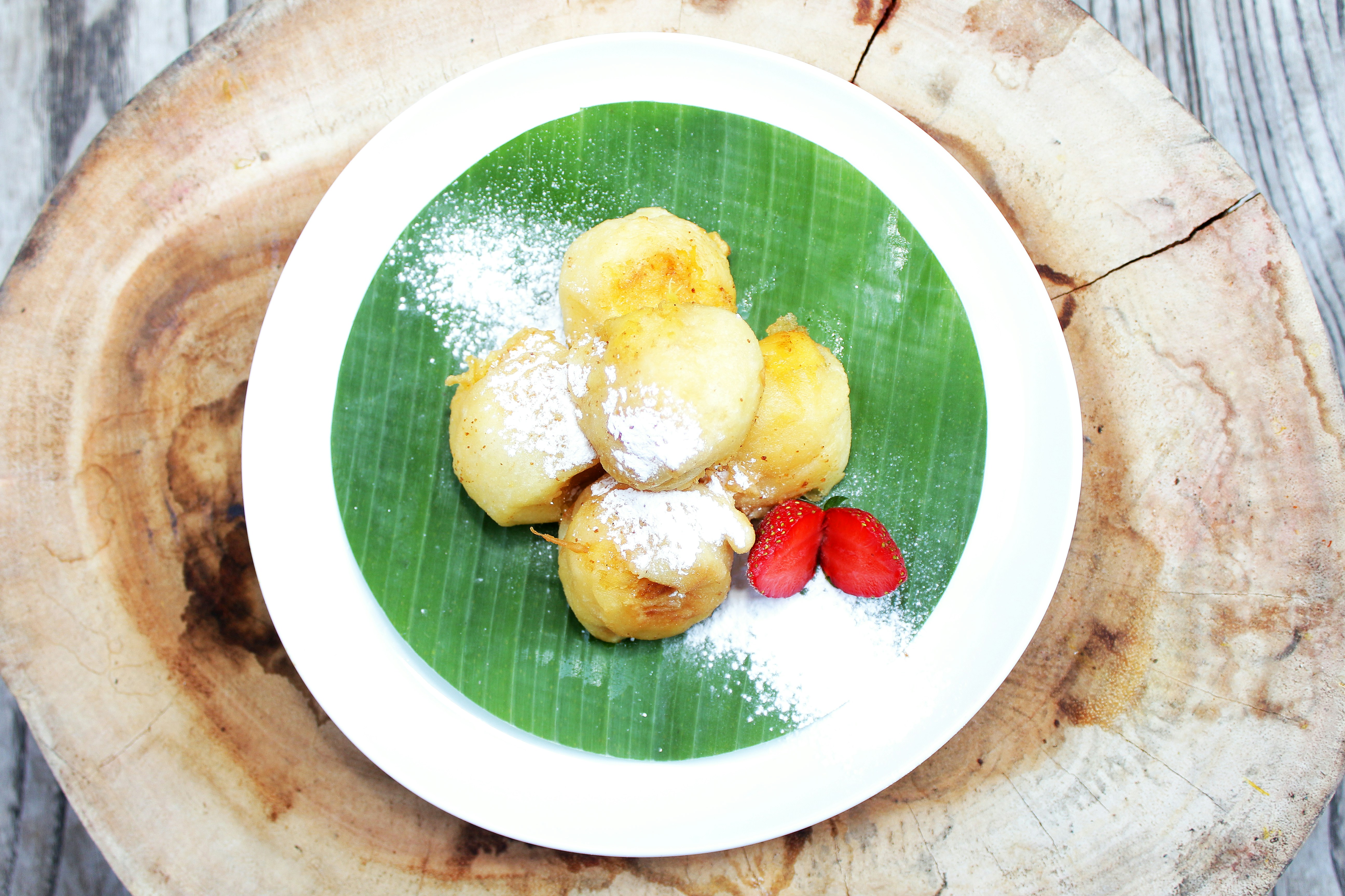 Indonesian famous street food or street snack, tape goreng or fried fermented cassava on the table, cassava tape (fermented cassava) is an Indonesian traditional food made by fermentation of cassava. Sweet, creamy, crunchy outside, a little oily and delicious.