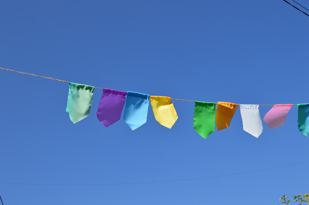 a group of colorful flags hanging from a line