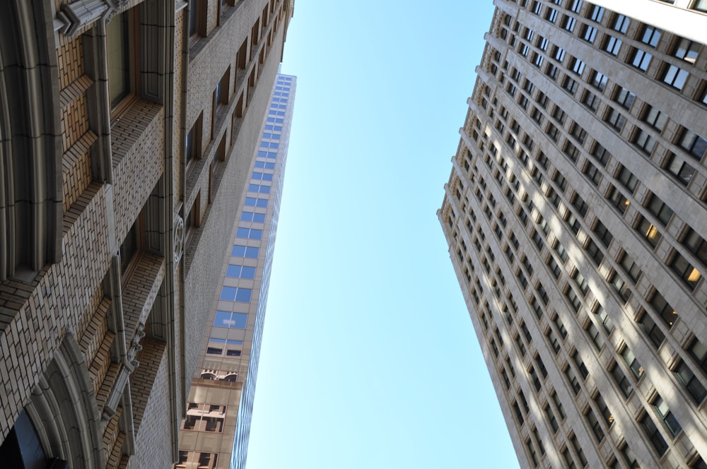 looking up at two tall buildings in a city