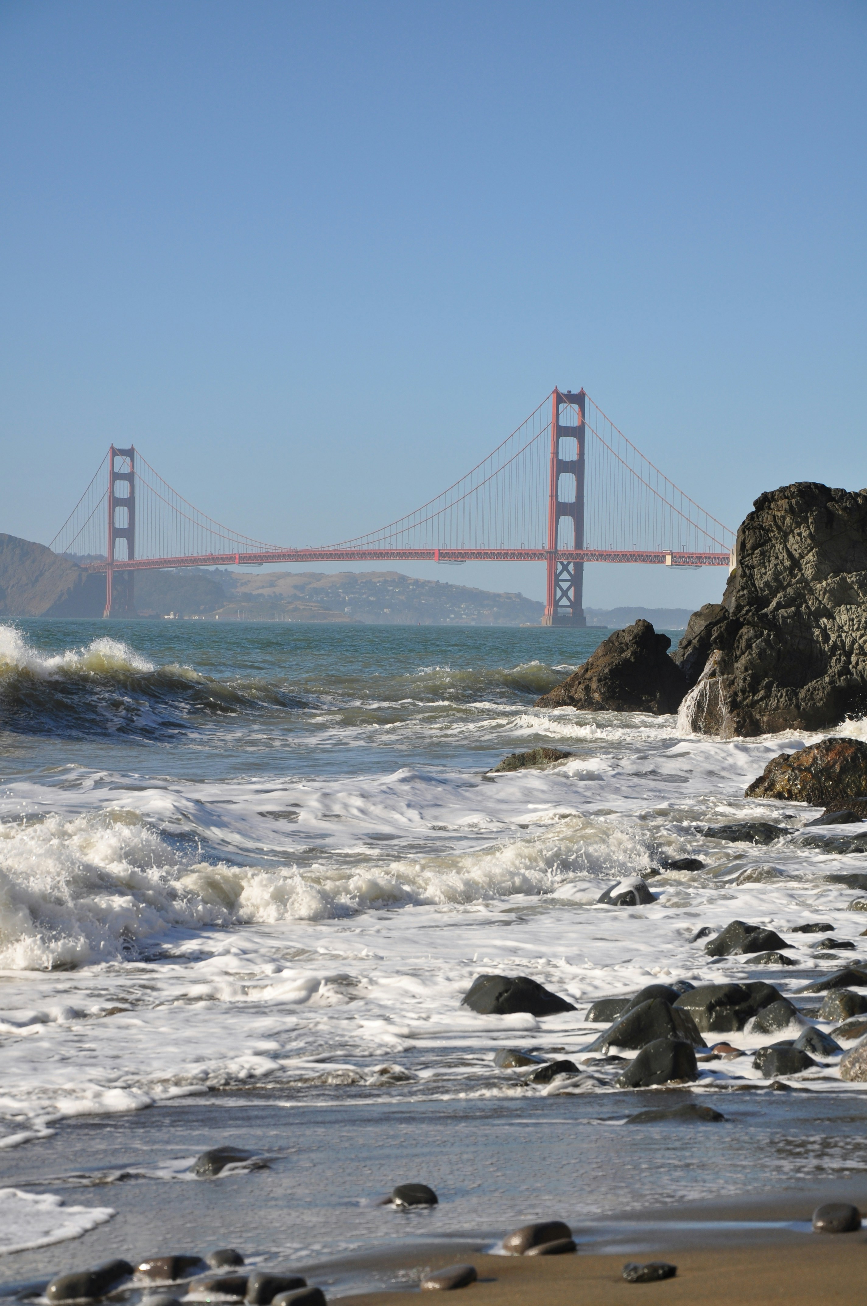a view of the golden gate bridge from the beach
