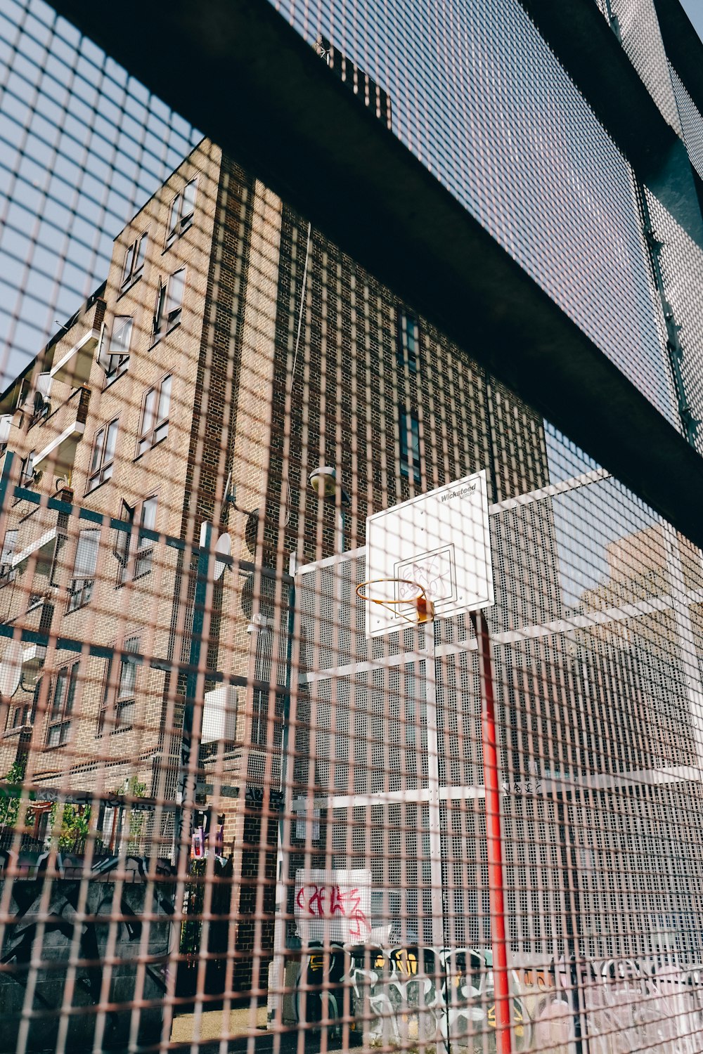 a view of a basketball court through a fence