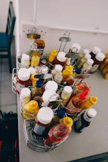 a metal basket filled with lots of condiments