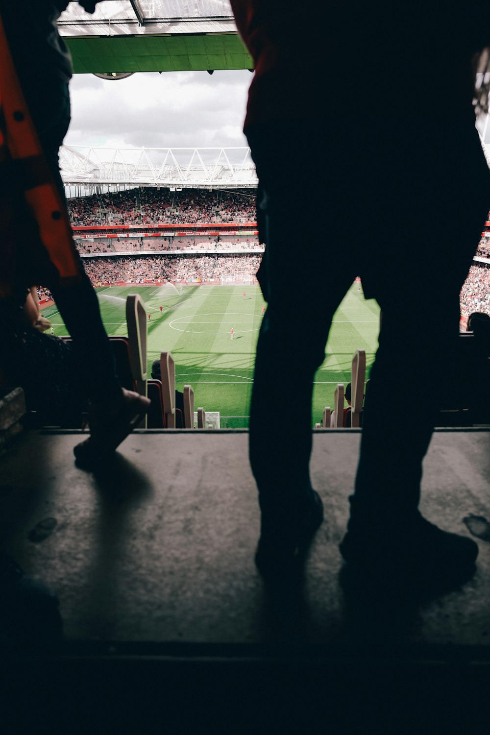 a couple of people standing in front of a soccer field