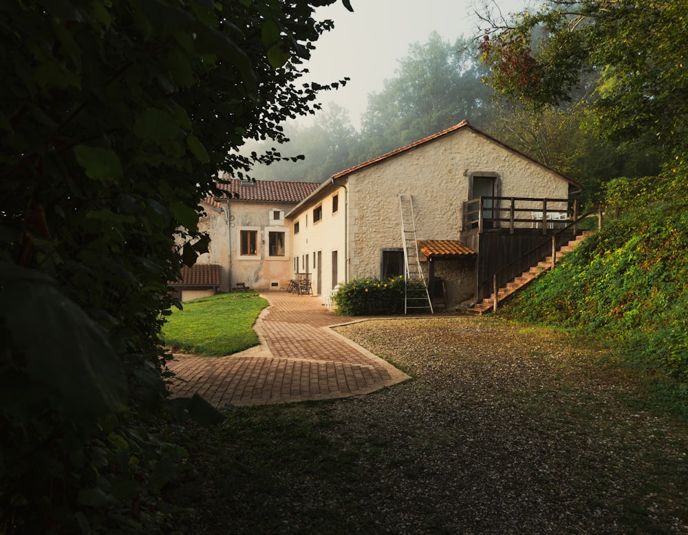 a house sitting on top of a lush green hillside