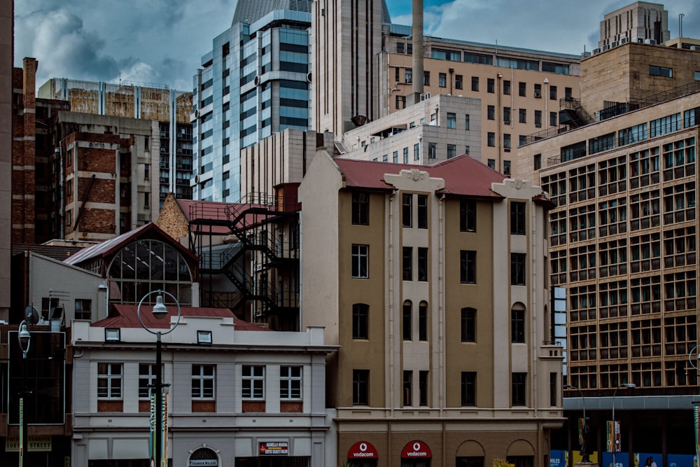 a group of buildings in a city with a cloudy sky