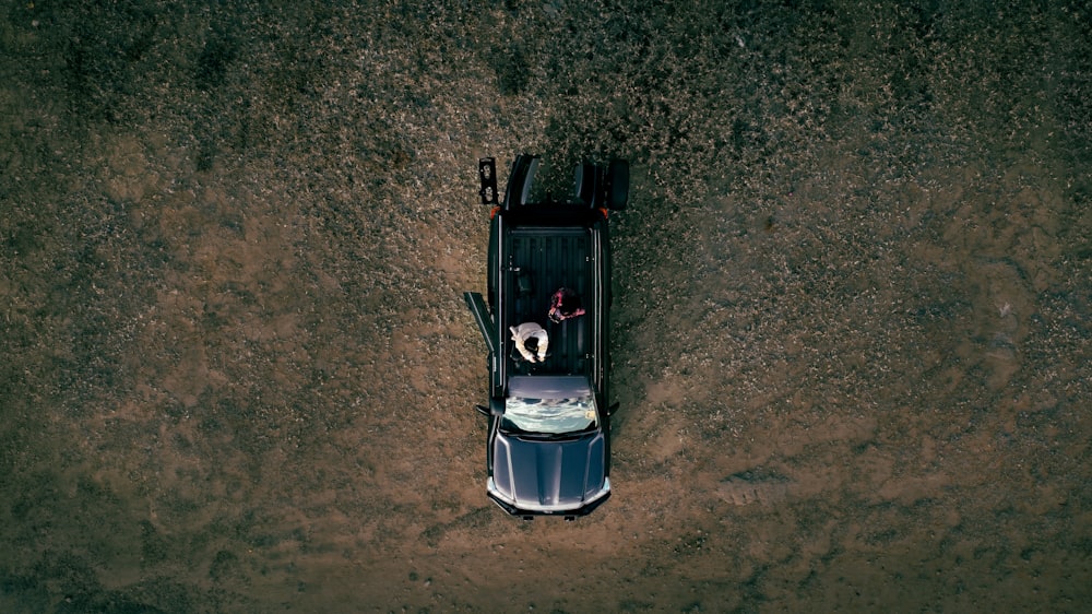 an aerial view of a car parked in the dirt