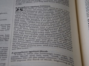 A close-up image of a page from a book, featuring text in English. The text is printed in black on a white page and appears to be from a religious or historical text. The heading is 'A prophecy against Ammon' followed by a numbered paragraph. The font is clear with bold headings.
