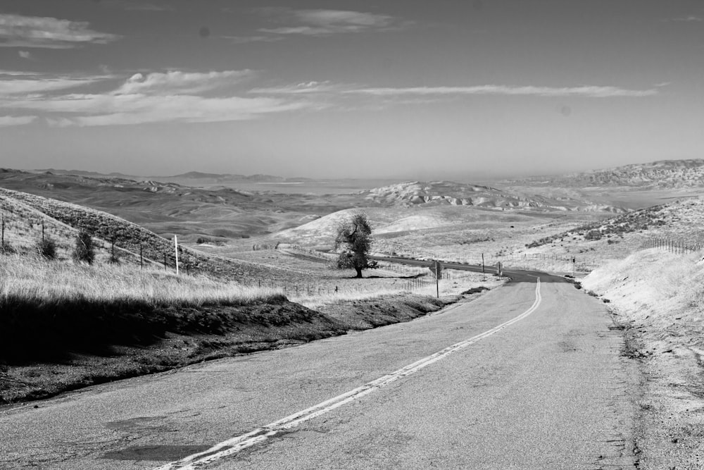 a black and white photo of a country road