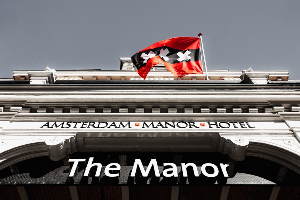 a red and black flag on top of a building