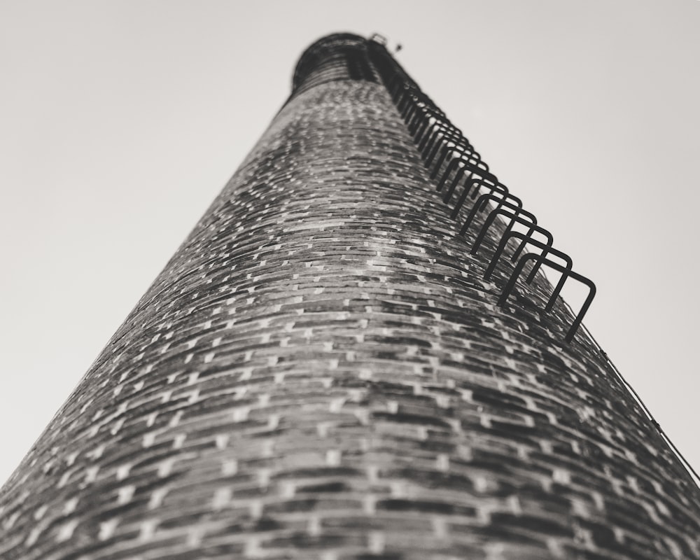 a black and white photo of a brick tower