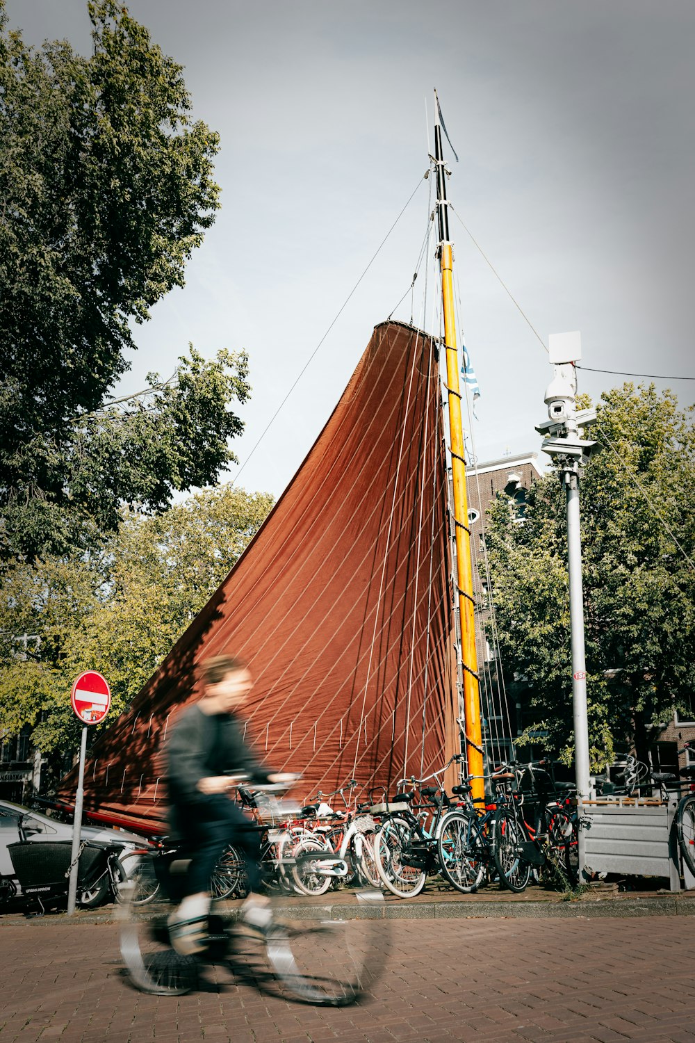 a man riding a bike past a large boat