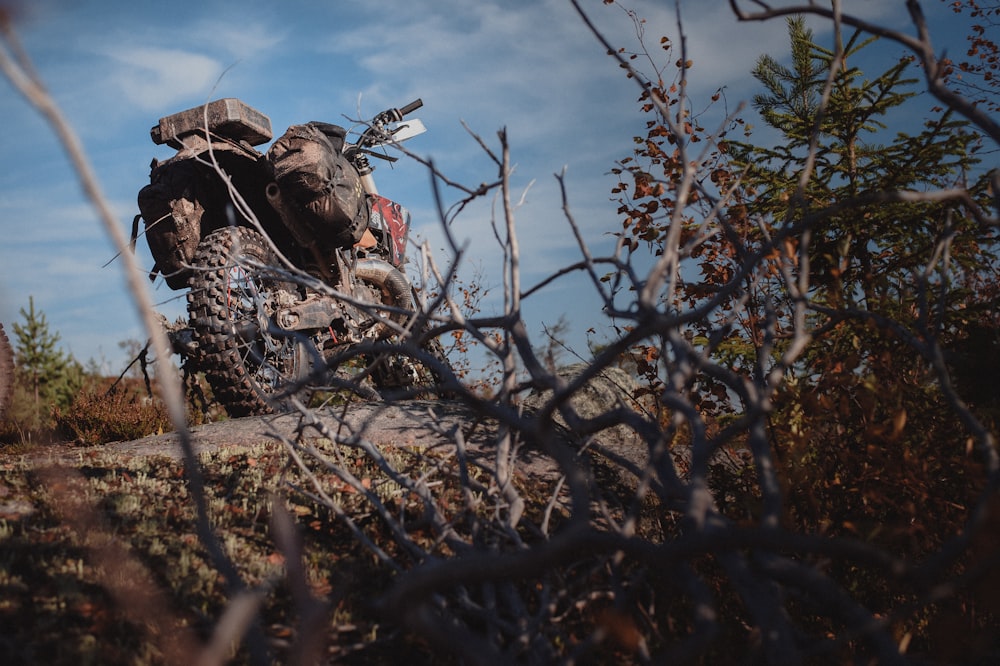 a man riding a motorcycle down a dirt road