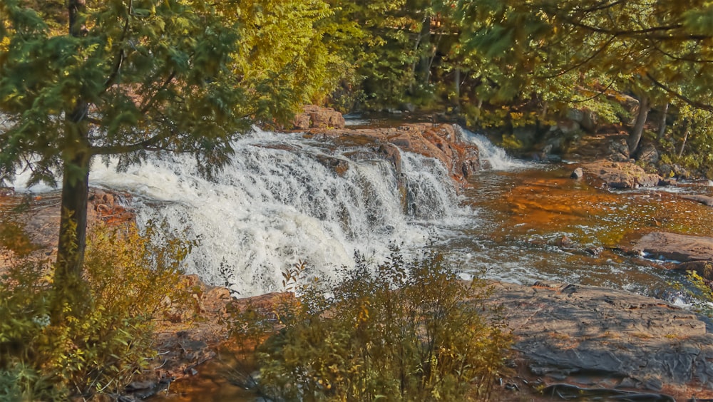 a painting of a waterfall in the woods