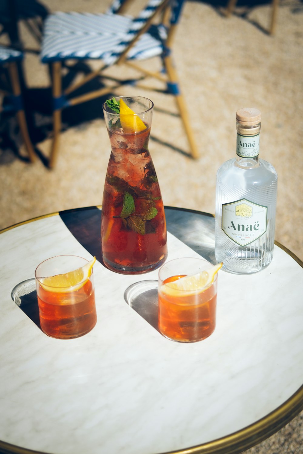 a table with two glasses and a pitcher on it