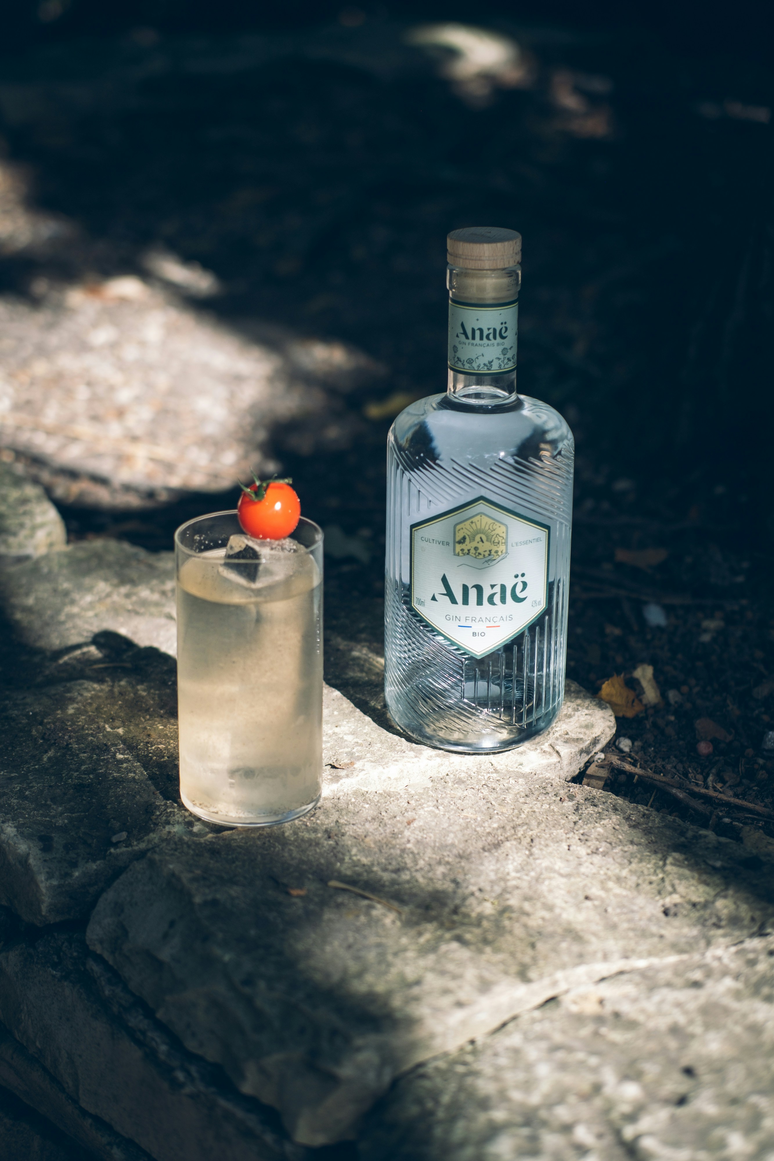 a bottle of alcohol sitting next to a glass