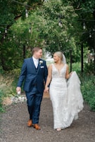 A cinematic wide shot of a couple walking hand-in-hand through a lush garden path lined with fairy lights.