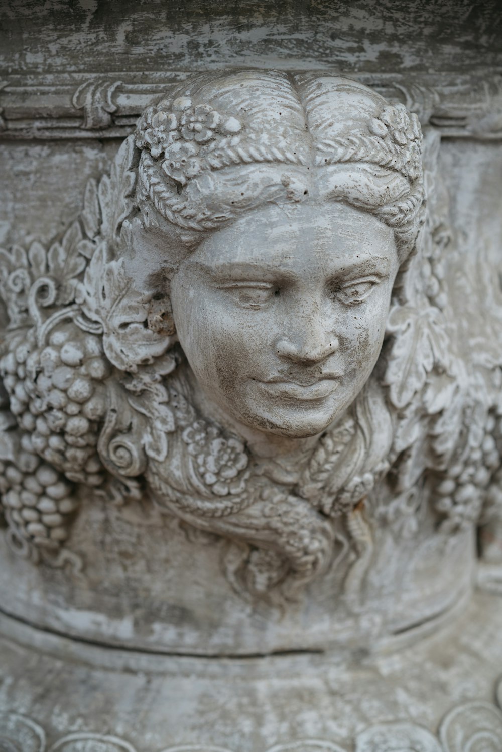a close up of a statue of a woman's head
