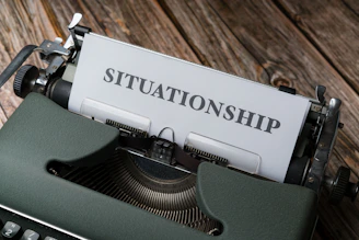 a close up of a typewriter with a sign on it