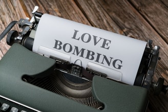 a typewriter with a love bombing paper on it