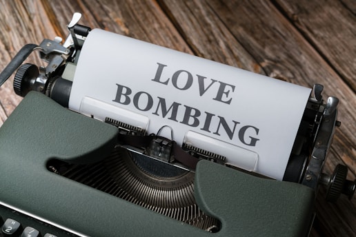 a typewriter with a love bombing paper on it