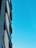 A stunning modern building with sleek lines and expansive glass windows set against a clear blue sky.