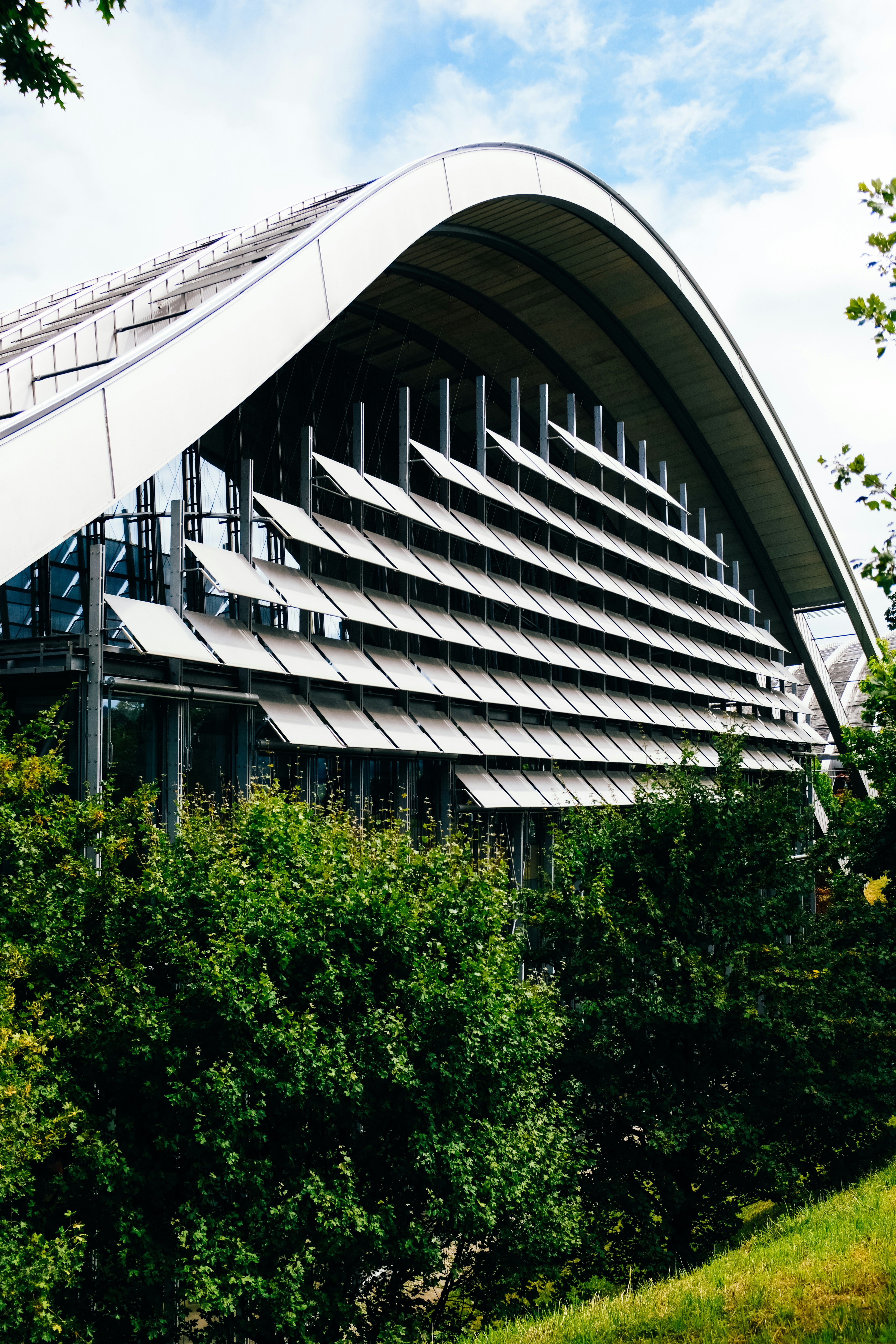 a building with a curved roof and a white roof