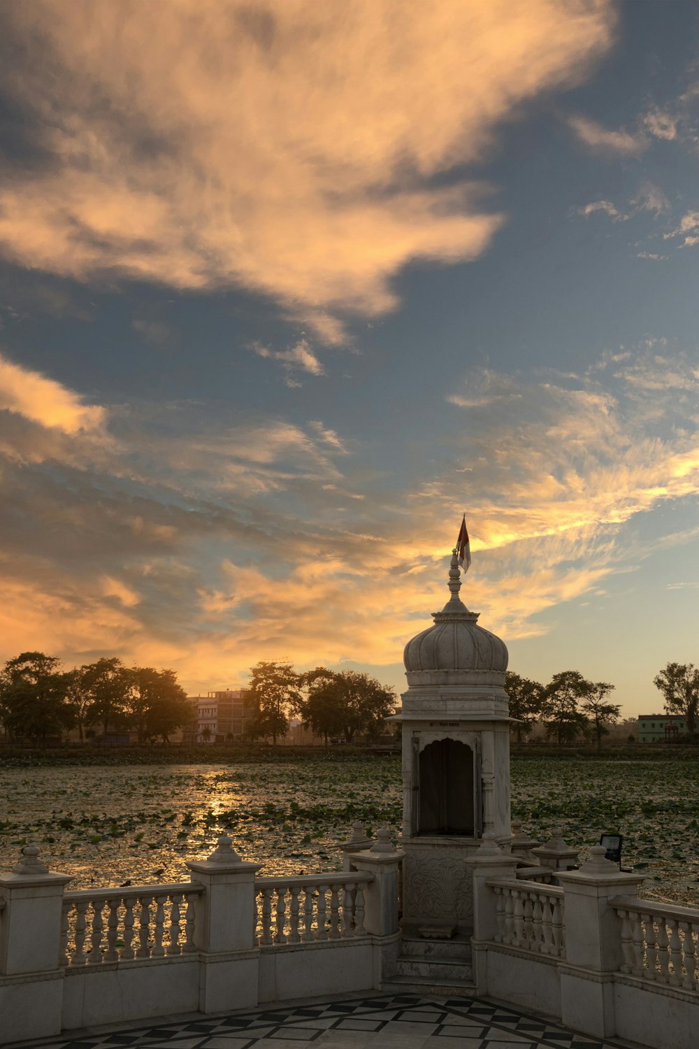 a clock tower in front of a body of water