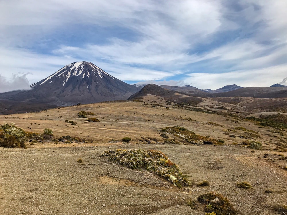 a mountain with a snow capped peak in the distance