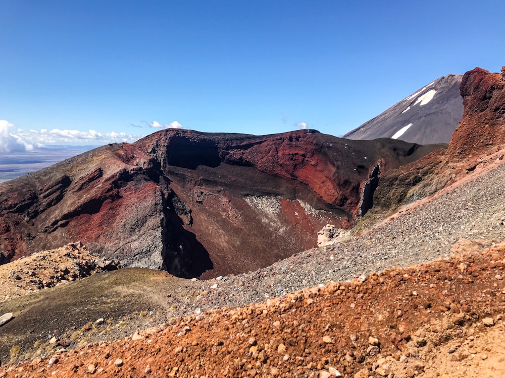 a view of a mountain range from the top of a hill