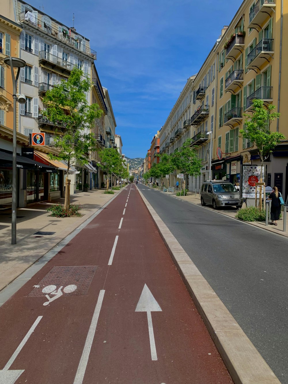 an empty street with a white arrow painted on it