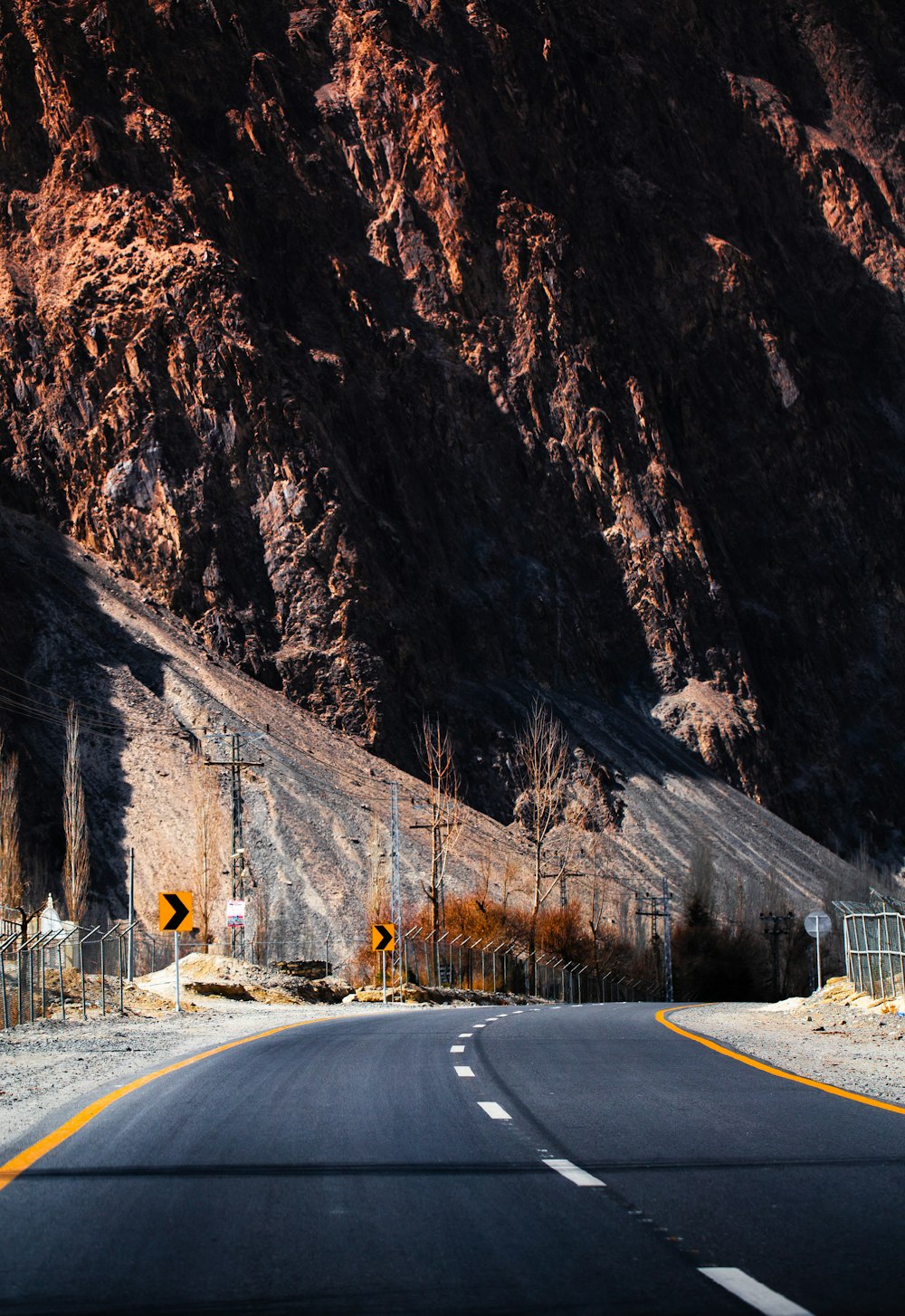 a road with a mountain in the background