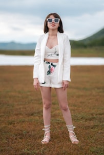 A stylish woman wearing a beautifully tailored linen outfit in a natural setting.