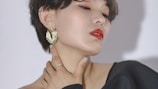 a woman with her hand on her neck