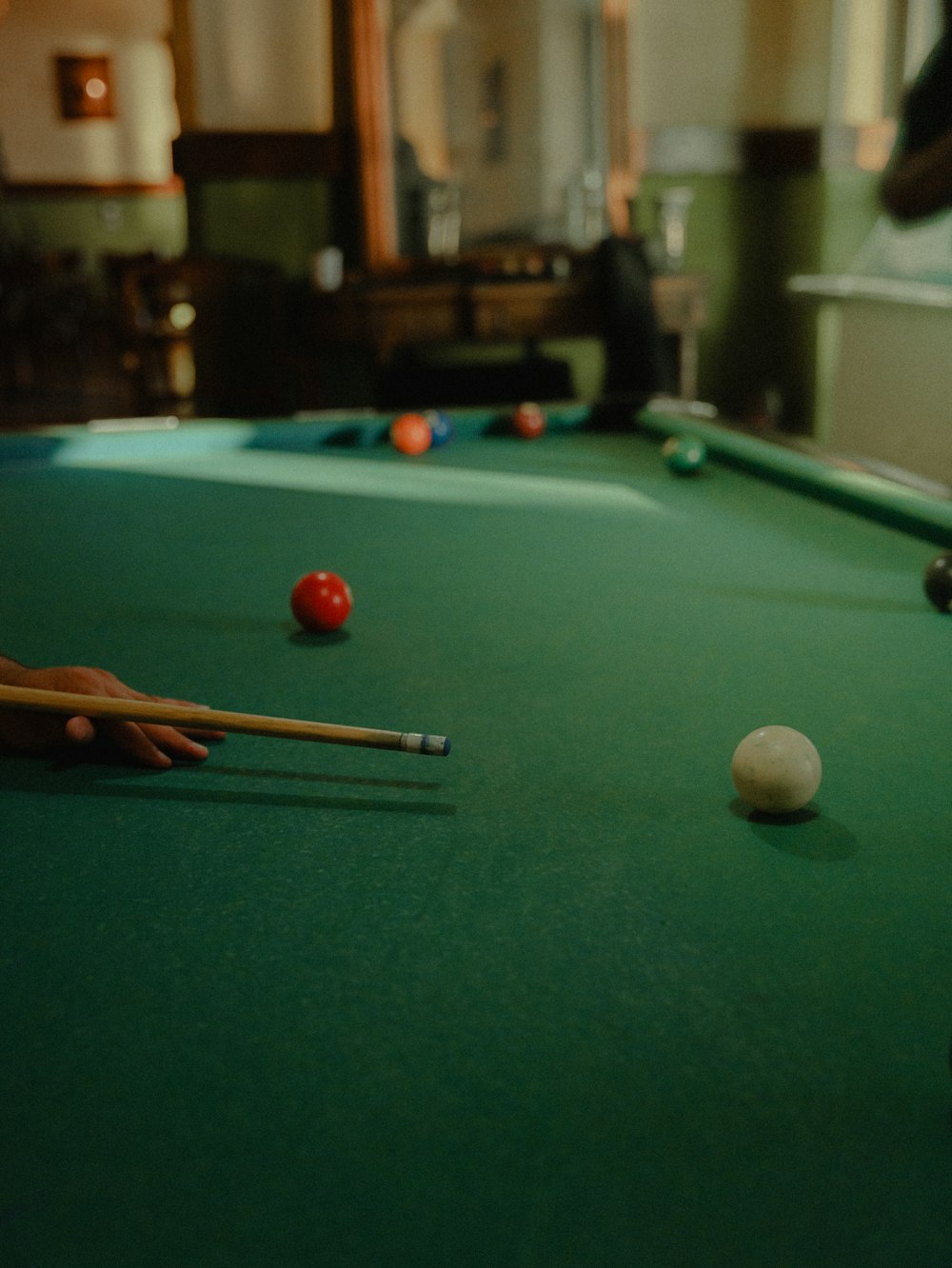 a pool table with a pool ball and cues