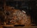 A cluttered workshop filled with woodworking tools, photos pinned on a bulletin board, and a guitar body in progress on the workbench. The scene is dimly lit by a lamp, adding a cozy, vintage feel to the space.
