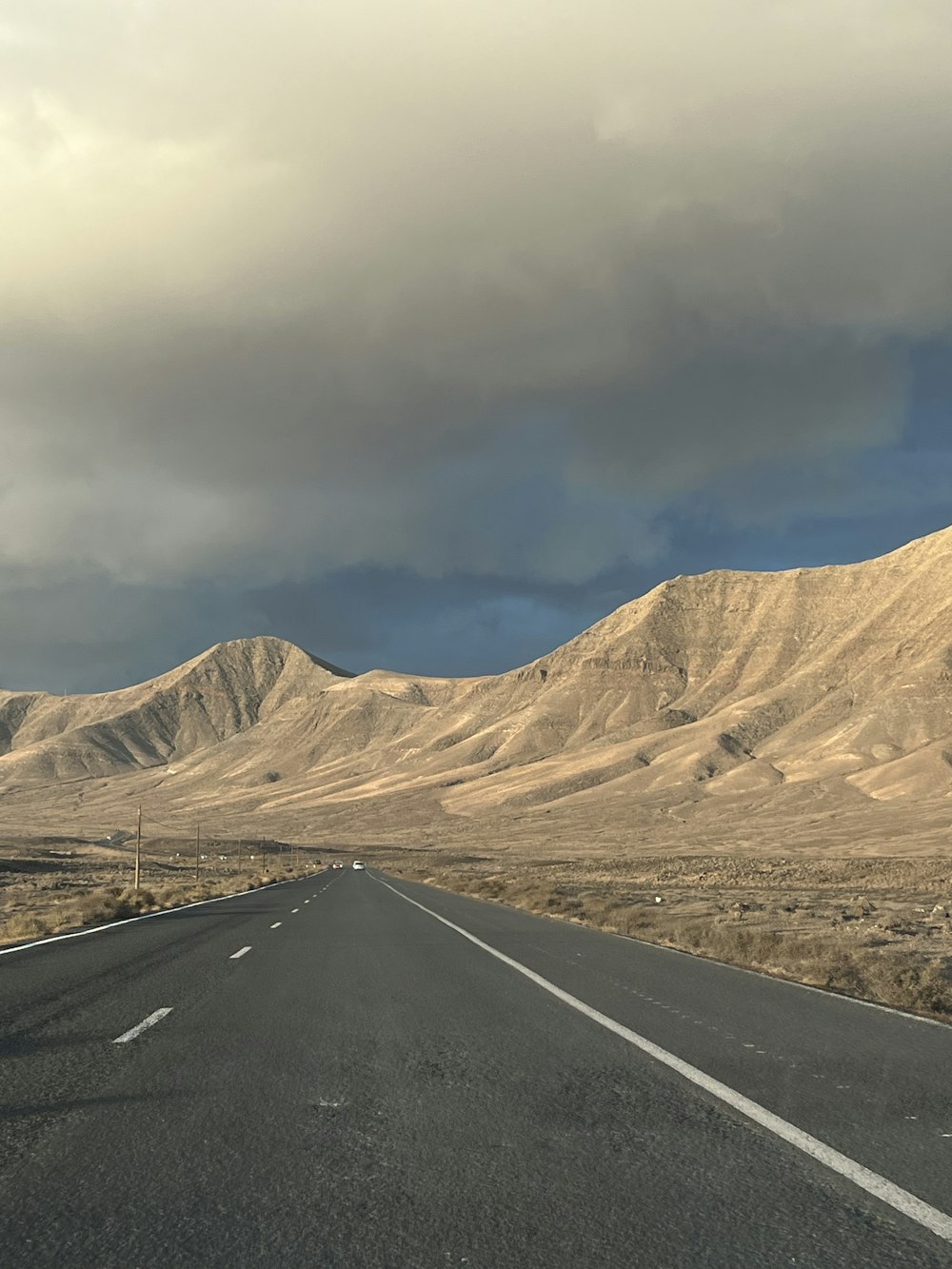 an empty road in the middle of a desert