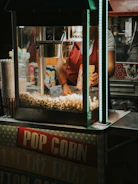 Close-up of a sleek vending machine dispensing fresh popcorn in a bright, modern setting