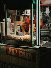Close-up of a sleek vending machine dispensing fresh popcorn in a bright, modern setting