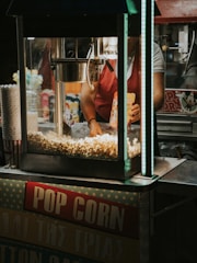 Live popcorn machine at a festive birthday party with smiling guests.