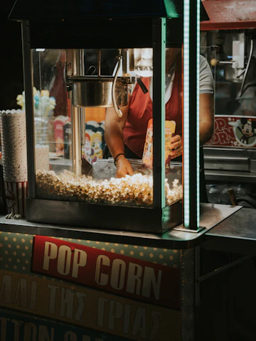 Modern vending machine dispensing fresh popcorn in a bright, welcoming university hallway.