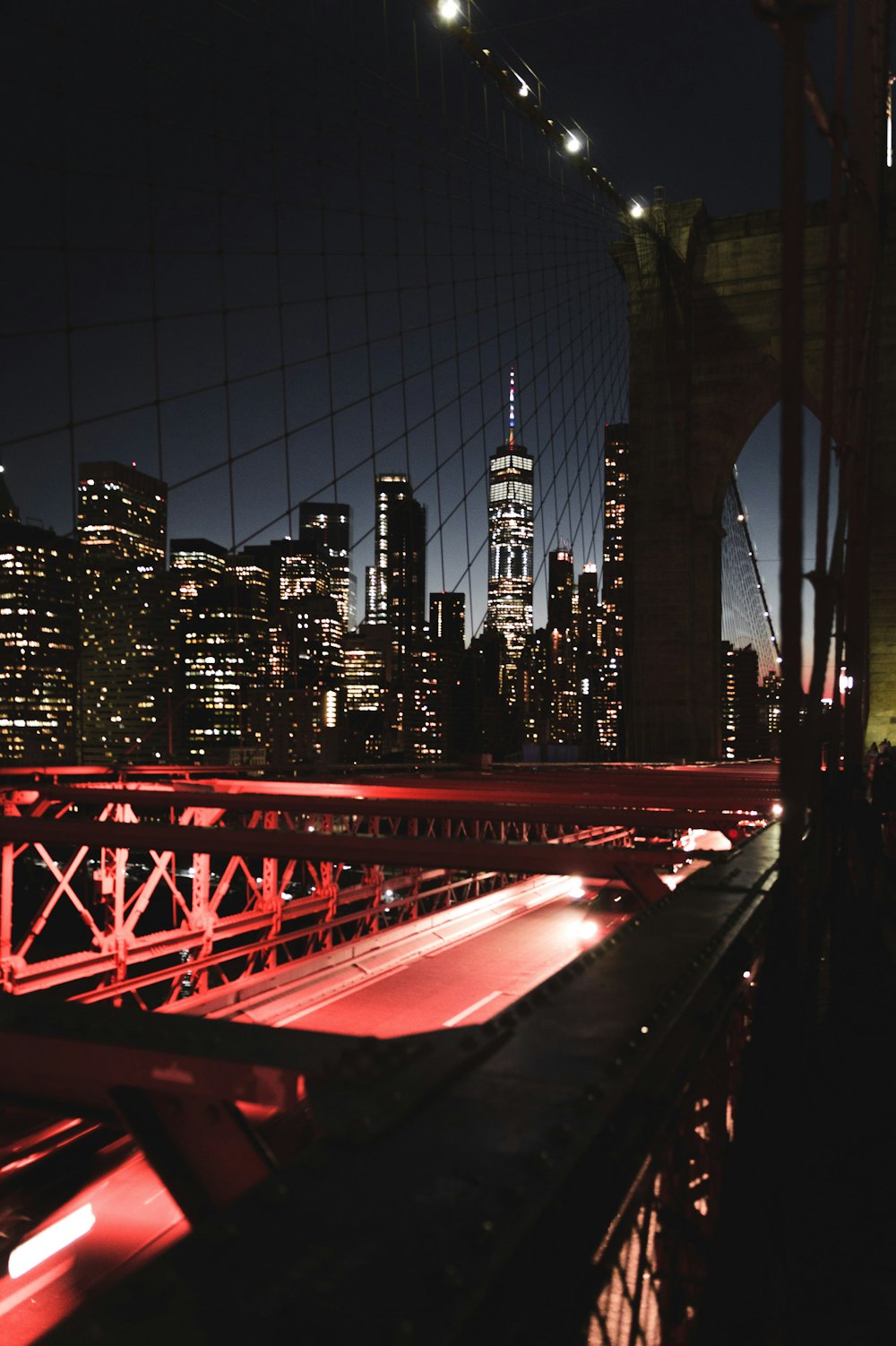 a view of a city at night from a bridge