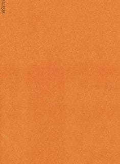 A plain, textured surface in a solid burnt orange color with a visible print of alphanumeric code in the corner.