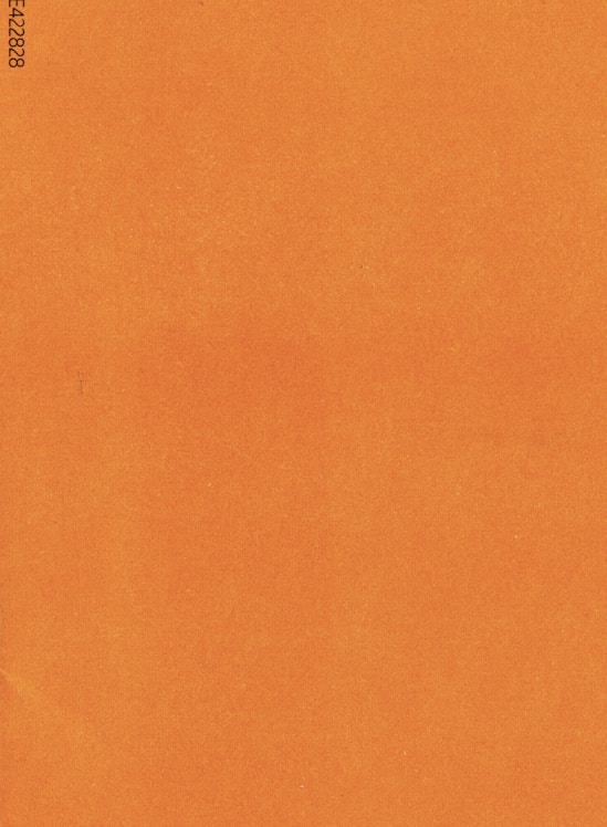 an orange piece of paper with a black border