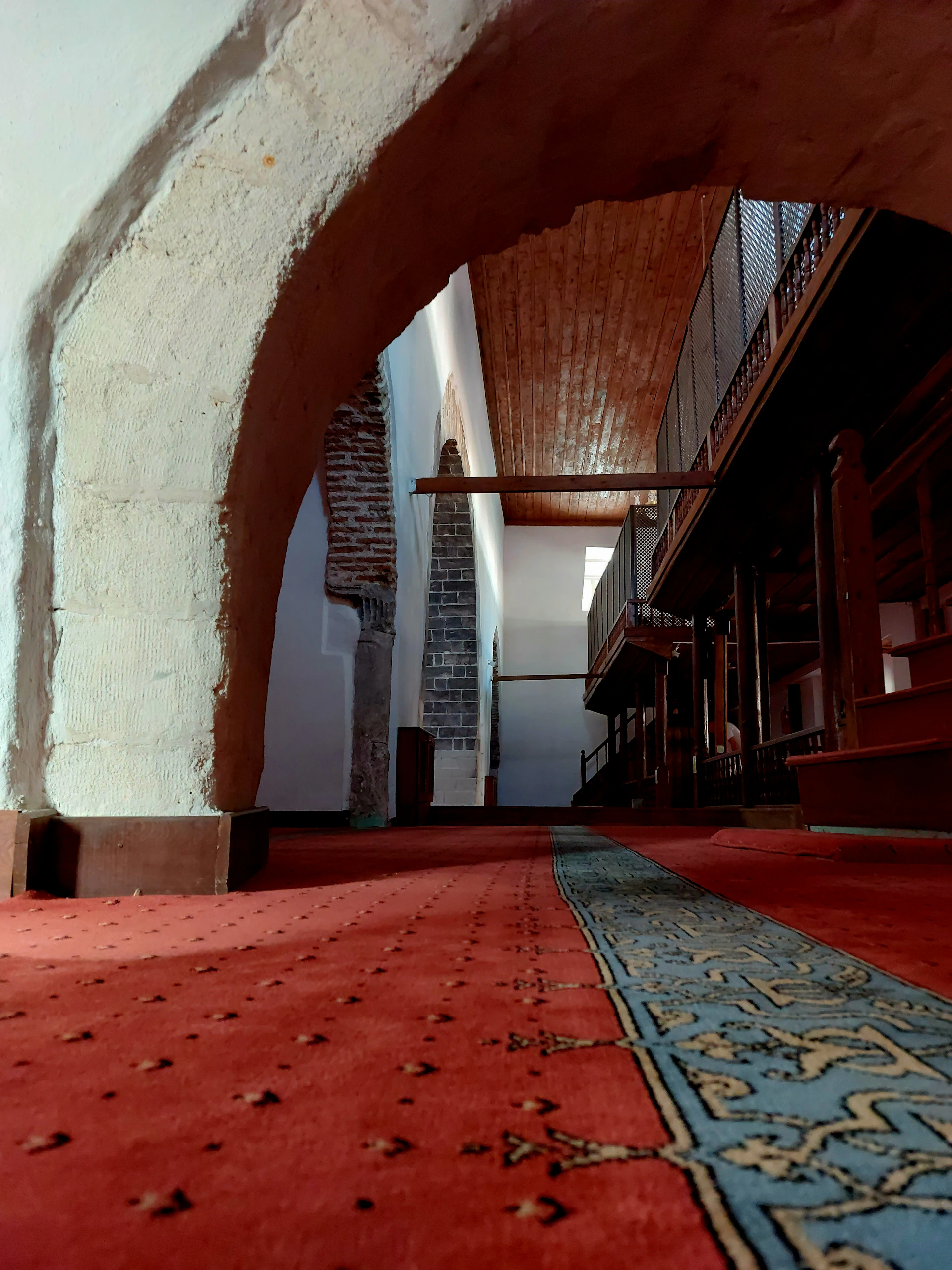 a red carpet with a blue rug underneath it