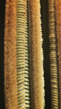 Close-up of textured fabric in muted green and warm beige shades