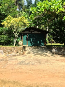 Front view of a cozy green and brown house with a small garden in Gravataí.
