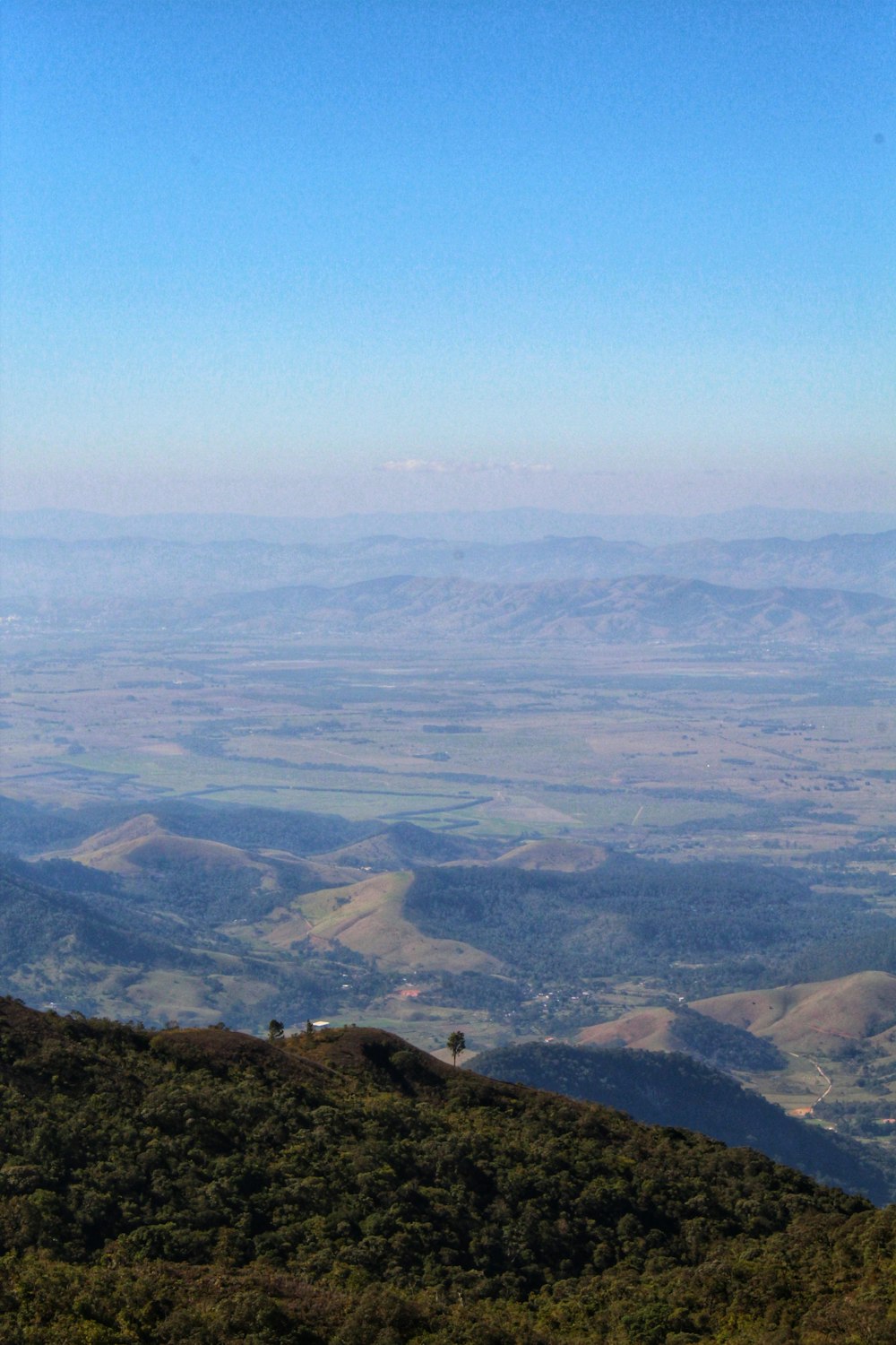 a bench on a hill overlooking a valley